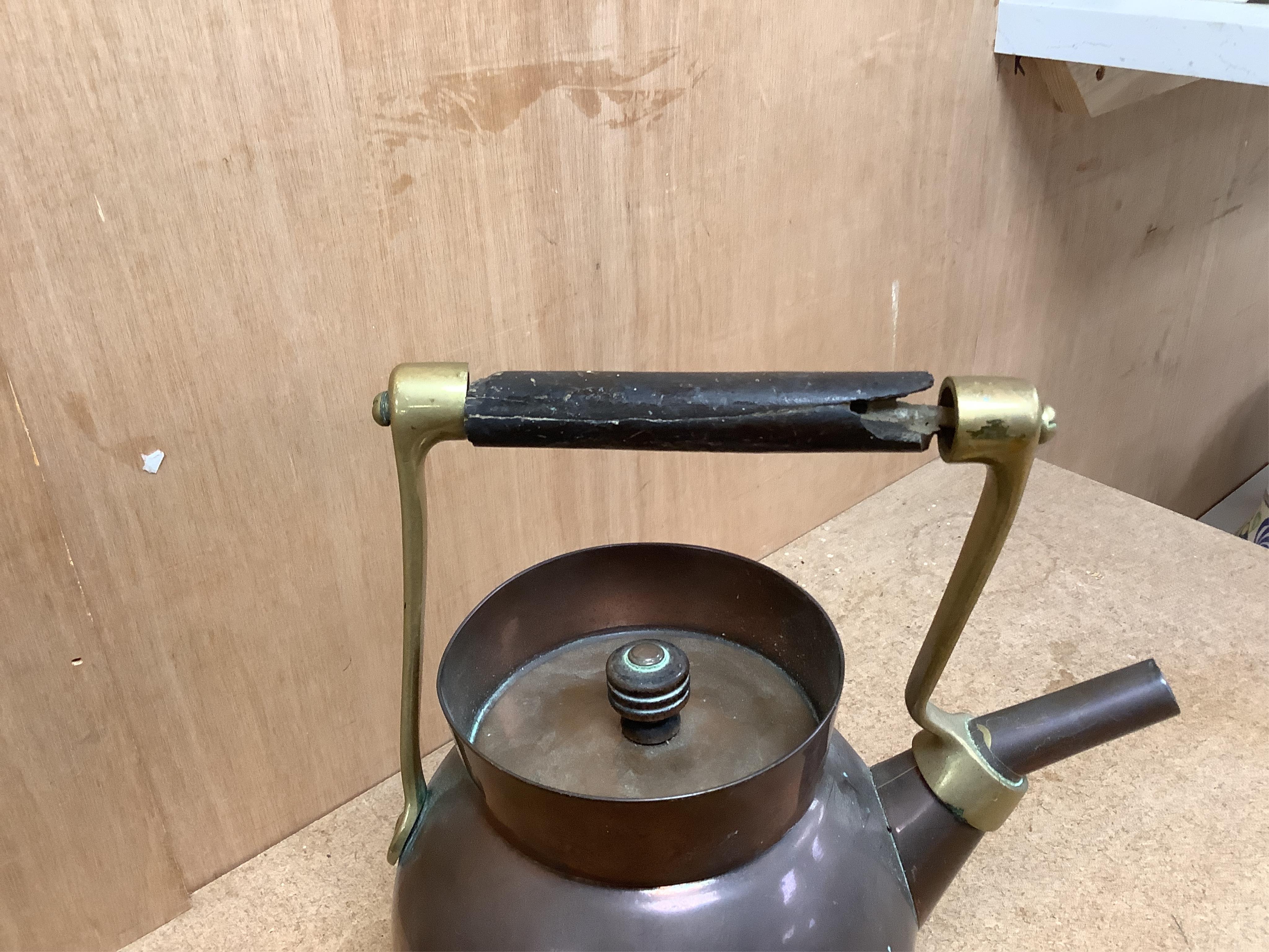 An Arts and crafts copper and brass Benham & Froud stamped Christopher Dresser teapot, (A.F), together with a two handle tray stamped Torini &Sons, Tray 49cm wide.